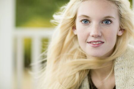 Close up of young woman with hair blowing outdoorsの写真素材