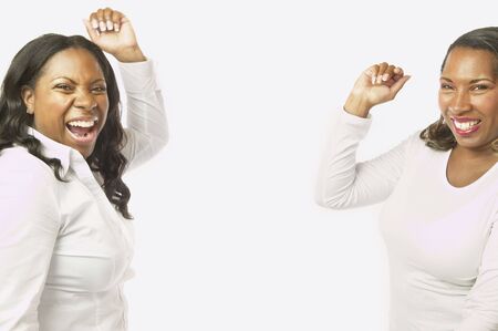 Adult African sisters laughing and dancingの写真素材