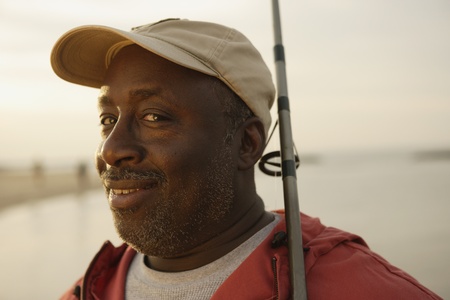 Close up of African man holding fishing poleの写真素材