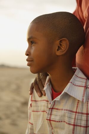 Close up of young African boy at beachの写真素材