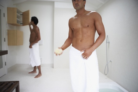 Two men in towels in bathroom