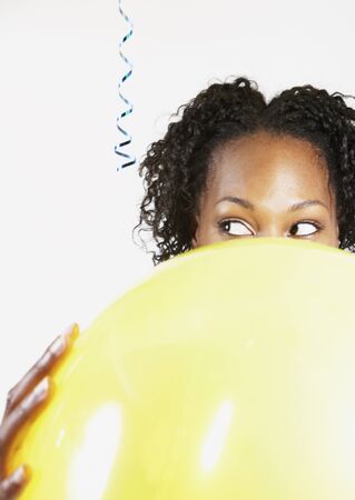 African woman holding balloonの写真素材