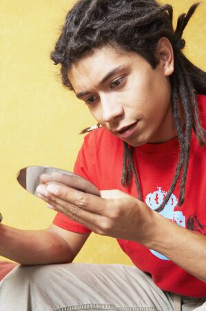 Hispanic man looking at cdの写真素材