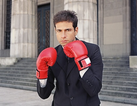 Businessman wearing boxing gloves