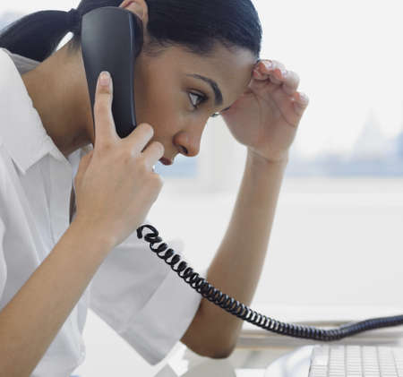African businesswoman talking on telephoneの写真素材