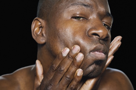 African man with hands on faceの写真素材