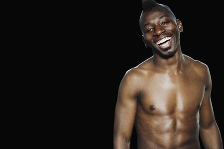 Studio shot of bare-chested African manの写真素材