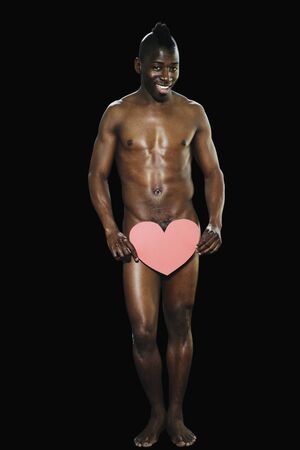Nude African man with heart in front of genital areaの写真素材