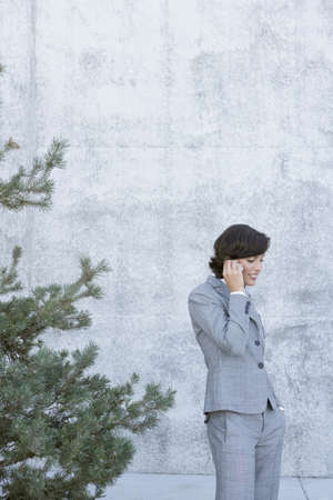 Hispanic businesswoman talking on cell phoneの写真素材