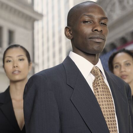 African businessman with businesswomen in backgroundの写真素材