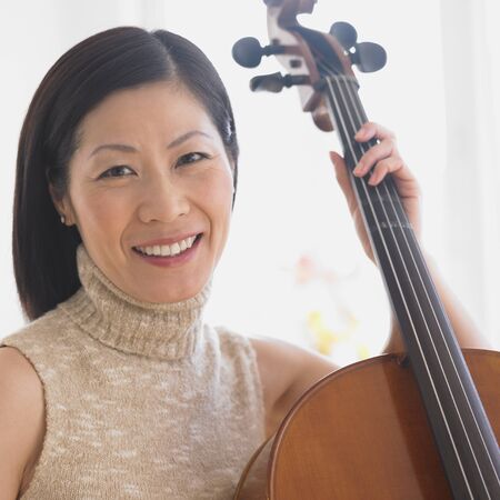 Close up of Middle-aged Asian woman with celloの写真素材