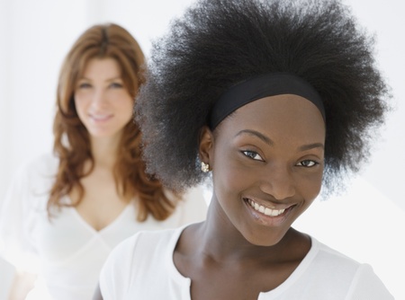 African woman smiling with friend in backgroundの写真素材
