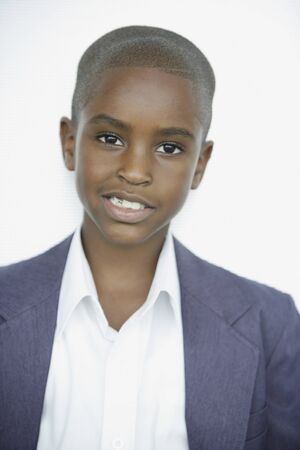 Close up of African boy in suit jacketの写真素材