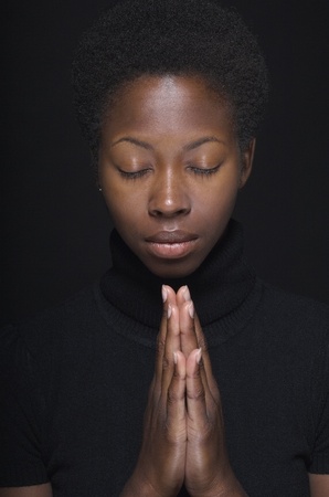 Close up of African woman prayingの写真素材