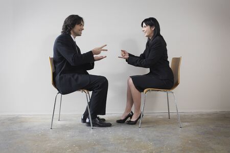 Businesspeople playing rock paper scissorsの写真素材