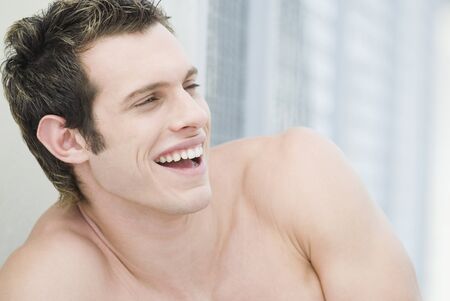 Bare-chested man laughingの写真素材