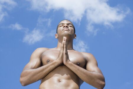 Bare-chested African man meditatingの写真素材