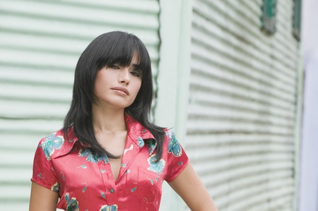 Hispanic woman standing in front of aluminum sidingの写真素材