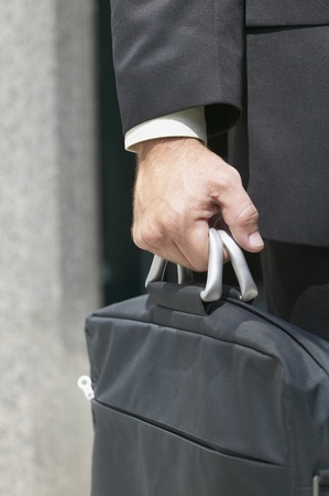 Close up of businessman carrying briefcaseの写真素材