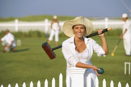 Young woman playing croquet
