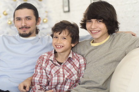 Hispanic brothers sitting on sofaの写真素材