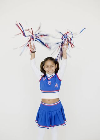 Hispanic girl dressed as cheerleaderの写真素材
