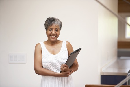 Senior African businesswoman holding paperworkの写真素材