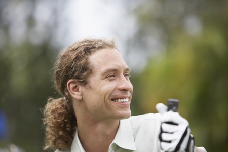 Man holding golf clubの写真素材