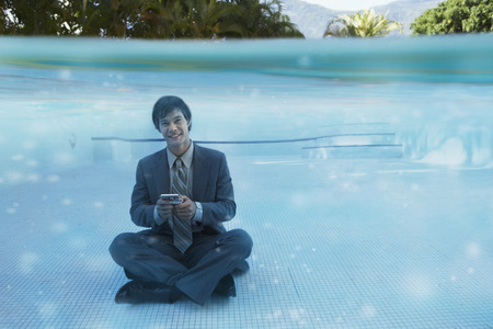South American businessman in swimming poolの写真素材