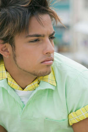 Young Hispanic man looking to side