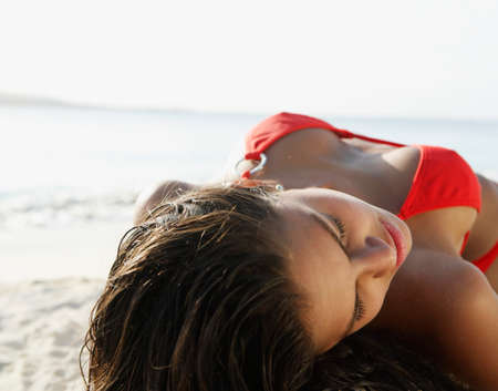 South American woman laying on beach