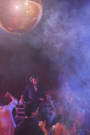 Hispanic dj playing at nightclub