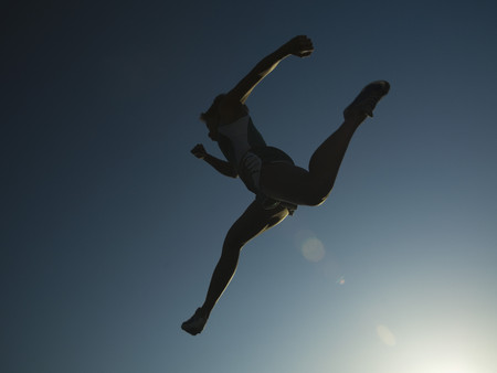 African American female athlete jumping