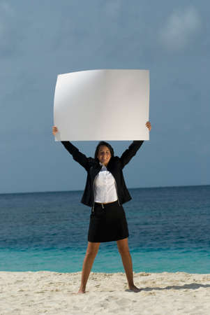 Hispanic businesswoman holding blank signの写真素材