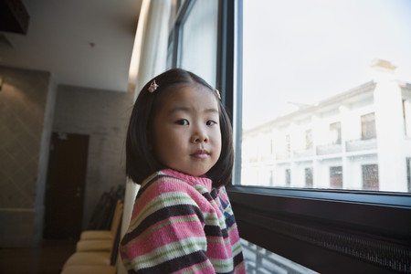 Asian girl next to windowの写真素材