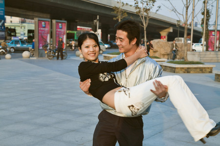 Asian man carrying girlfriendの写真素材