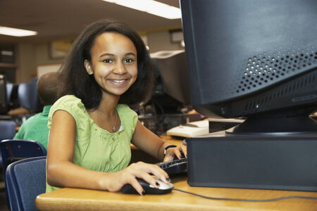 African American girl using school computer