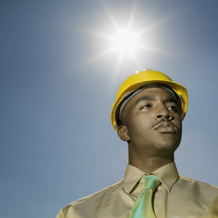 Low angle view of African American man wearing hard hat