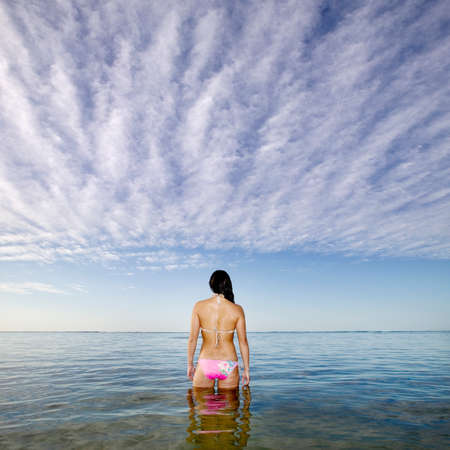 Pacific Islander woman standing in oceanの写真素材
