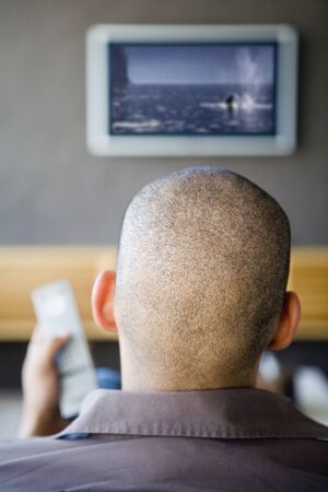 African American man watching television
