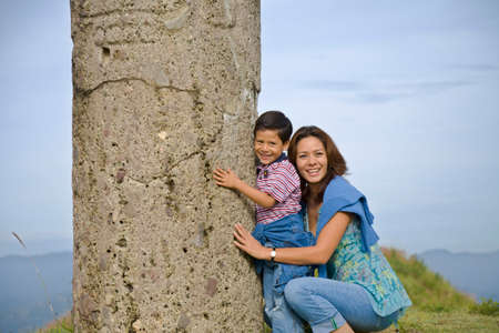 Hispanic mother and son hugging column, Oaxaca, Mexicoの写真素材