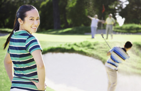 Asian woman on golf courseの写真素材