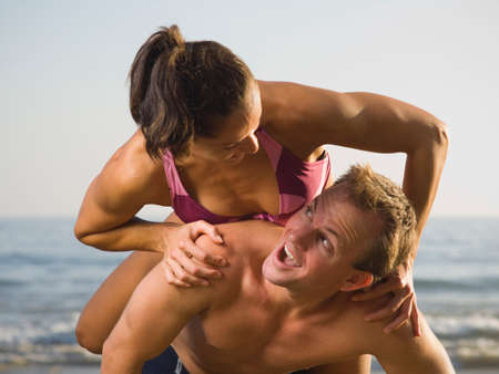 Multi-ethnic couple playing at beach