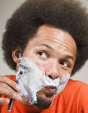 African man shaving faceの写真素材