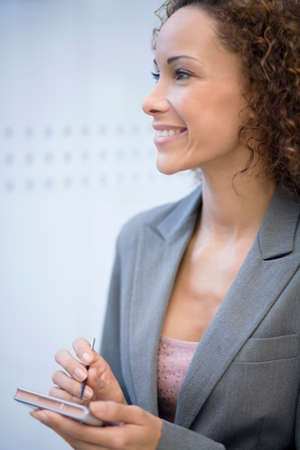 African businesswoman holding electronic organizerの写真素材