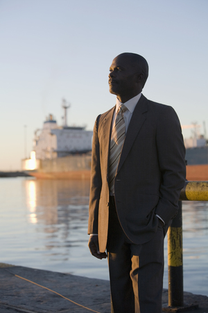 African American businessman on commercial pierの写真素材