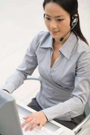 Asian businesswoman wearing headset