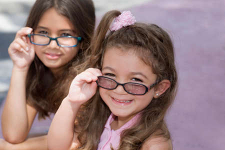 Hispanic sisters wearing eyeglassesの写真素材