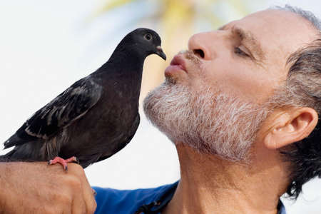 Man kissing birdの写真素材