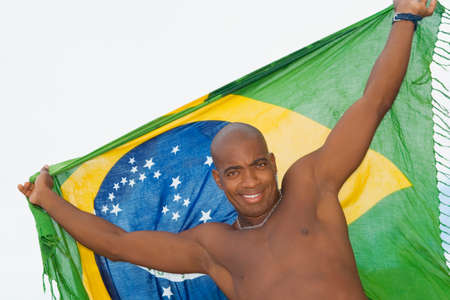 African man holding up beach wrapの写真素材